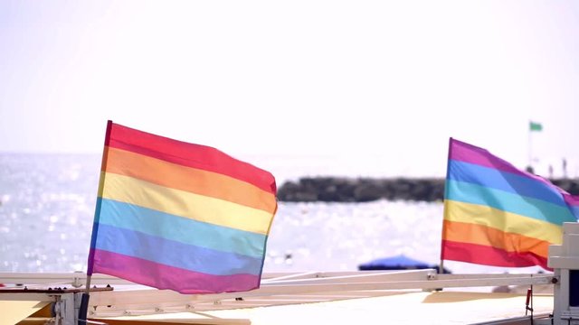 Slow motion gay pride flag blowing in the wind on Sitges, in Barcelona province. Perhaps Spain top gay destination, with LGTB events like Gay carnival, pride and Gay Spring break. Slowmotion from 120