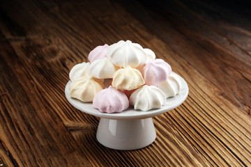 Meringue. Crispy white and pink twisted meringue. Concept love of sweet