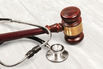 Gavel and stethoscope on background, symbol photo