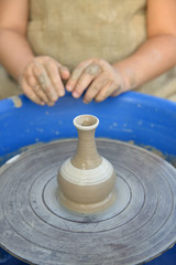 clay peas on the background of the hands of the pupil of pottery