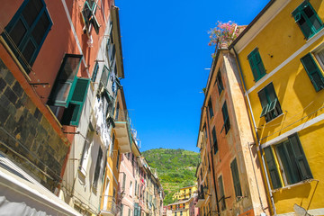 Obraz premium View on the beautiful colourful houses with clothes drying in the sunny daylight in Cique Terre, Italy.