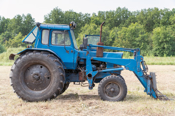 Tractor for working in the field and mowing grass