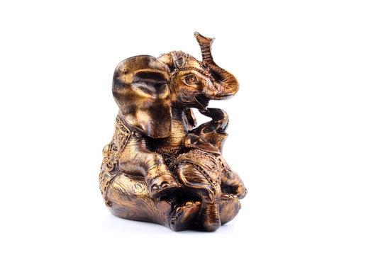 Gold Black Brown Engraved pattern gold elephant made of resin like wooden carving with white ivory. Stand on white background, Isolated, Art Model Thai Crafts, For decoration Like in the spa.