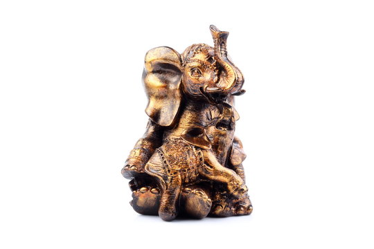 Gold Black Brown Engraved pattern gold elephant made of resin like wooden carving with white ivory. Stand on white background, Isolated, Art Model Thai Crafts, For decoration Like in the spa.
