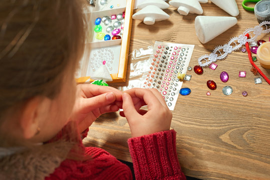 Childrens making decorations for new year holiday. Painting watercolors. Top view. Artwork workplace with creative accessories.