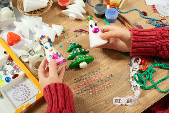Childrens making decorations for new year holiday. Painting watercolors. Top view. Artwork workplace with creative accessories.