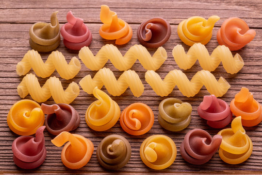colored pasta on wooden table