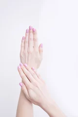 Poster Gentle pink manicure. Female hands on a white background © somemeans