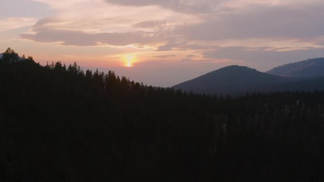 Side tracking shot of the sunset over Pattee Canyon near Missoula, Montana.