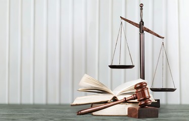 Justice Scales and books and wooden gavel on table. Justice