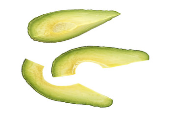 Slices of avocado on a white background, top view.