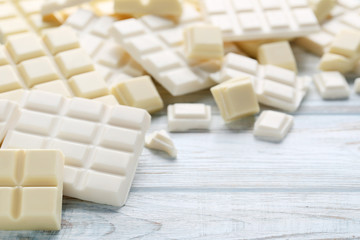 White chocolate pieces on wooden table