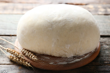 Raw dough on grey wooden table