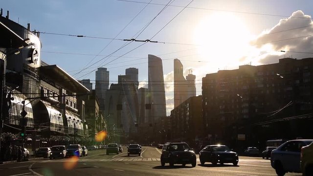 Timelapse view of the high-rise buildings and transport metropolis, flows of people and cars are regulated by traffic lights on multi-lane highways and road junction in Moscow.