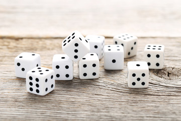White dice on grey wooden table