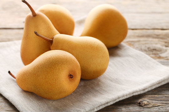 Ripe and sweet pears on grey wooden table