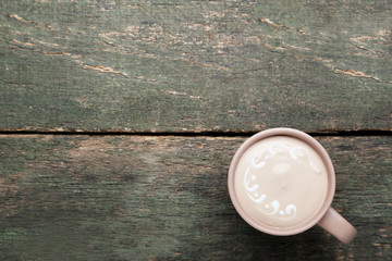 Cup of coffee on grey wooden table