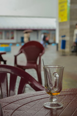 the forgotten empty  glass on a table, wet from a rain