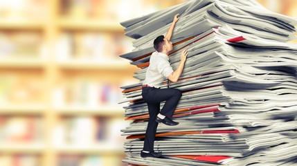 Businessmen climbing up a pile of documents on backround