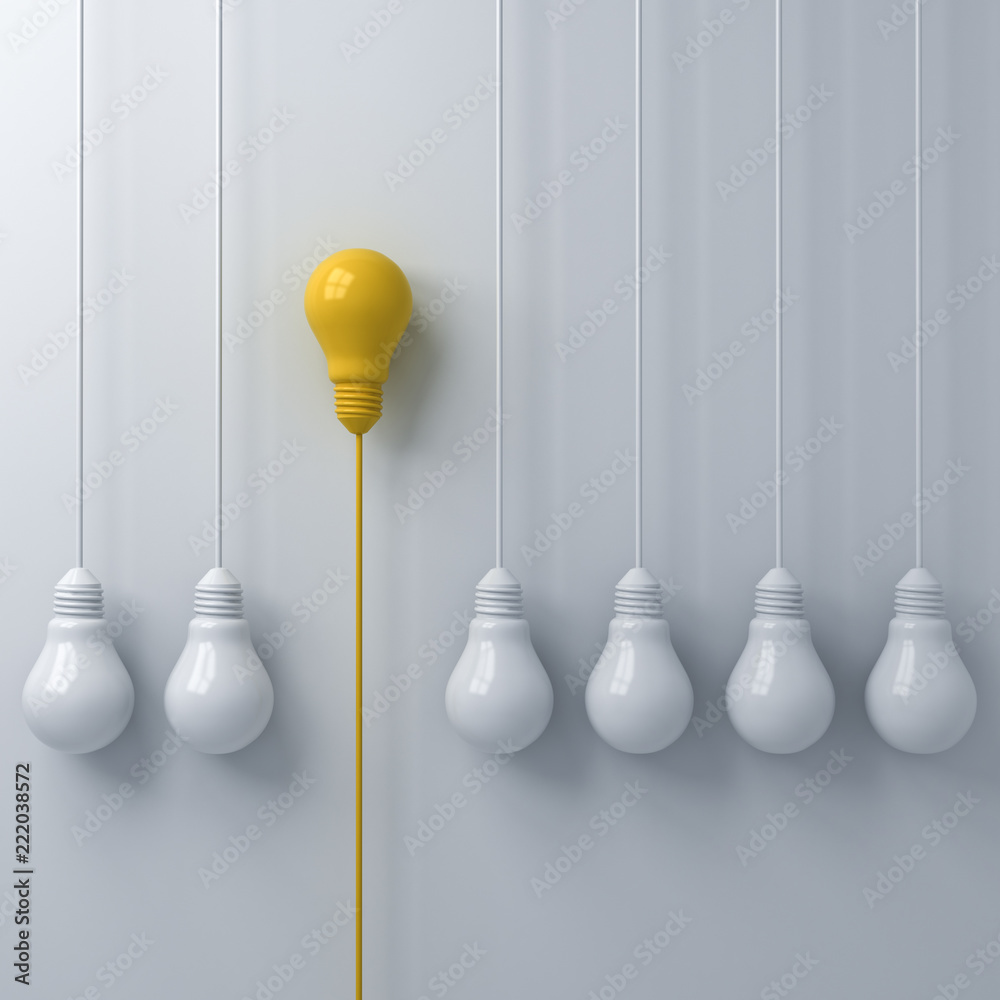Poster think different concept one hanging yellow light bulb standing out from the white light bulbs on whi