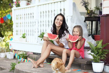 Girl on a wooden porch with watermelon