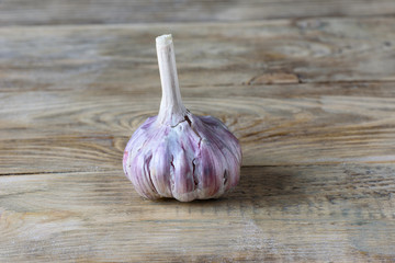 Rustic style. Bulb of garlic on wooden background