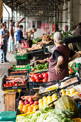 Saleswoman on a farmers market in stand in Bolhao Market in Oporto
