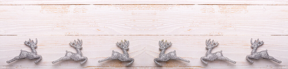 Silver christmas gifts on white wooden background. Top view. Copy space. Panorama