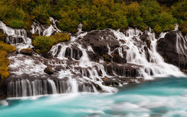 Hraunfossar Barnafoss waterfall Iceland, a series of waterfalls formed by rivulets streaming over a...