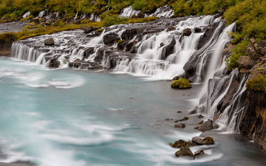 Hraunfossar Barnafoss waterfall Iceland, a series of waterfalls formed by rivulets streaming over a...