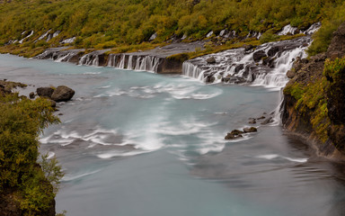 Hraunfossar Barnafoss waterfall Iceland, a series of waterfalls formed by rivulets streaming over a...