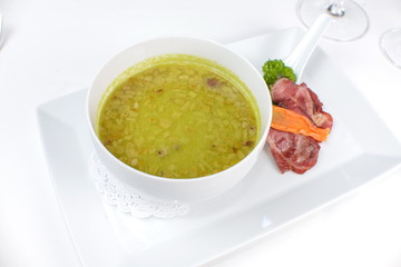onion soup with bacon and vegetables on a white background