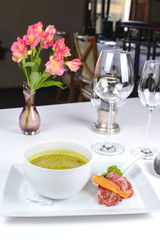 onion soup with bacon and vegetables on a white background