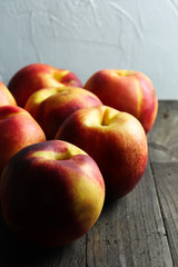 Group of ripe nectarines on dark wooden surface