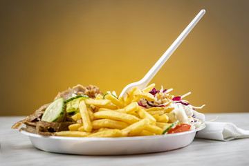 meat with kebab, French fries and salad