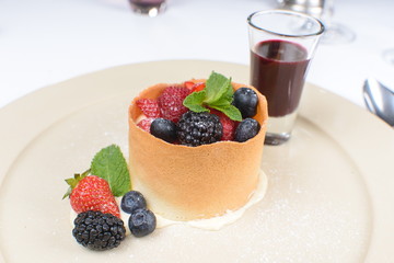 dessert with fruit and berry sauce