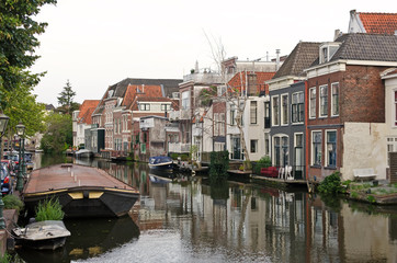 Fototapeta na wymiar Old typical dutch houses overlooking a canal. Leiden, The Netherlands. World water day.