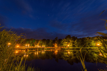 Fototapeta na wymiar Night shot over the lake with bridge and stars