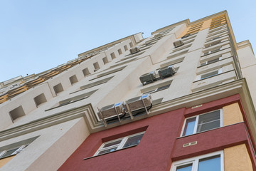 New high rise block building with air conditioners on facade. Modern apartments style.