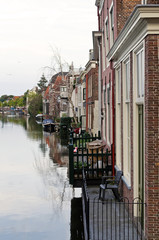 Fototapeta na wymiar Canal in Leiden. Beautiful old hauses with balconies overlooking the canal. World water day.