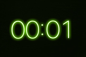 Digital clock timer stopwatch display showing 1 one second remaining in glowing green numbers....