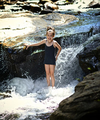 Girl Playing in Waterfall