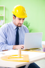 Young male architect working at the project