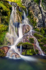 Fotobehang Beautiful natural waterfall over rocks and moss © ionutpetrea