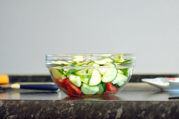 Fresh vegetable salad in a glass bowl.