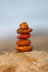 Fototapeta na wymiar Zen like summer background, stones on the rock at the beach 