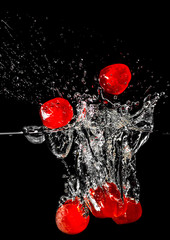 Red glazed cherries dropped into liquid