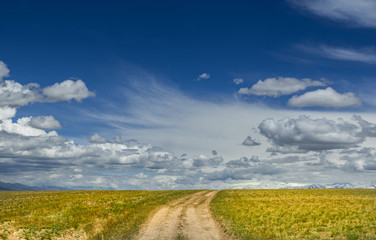 Dirt road. Summer sky. Freedom. Landscape. Sunny day sky.