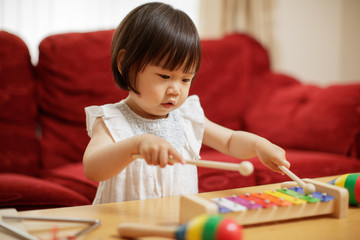 baby girl play xylophone at home © M-image