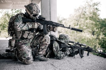 Military soldiers in camouflage took a firing position in the destroyed, abandoned building of the city. Urban warfare, urban warfare